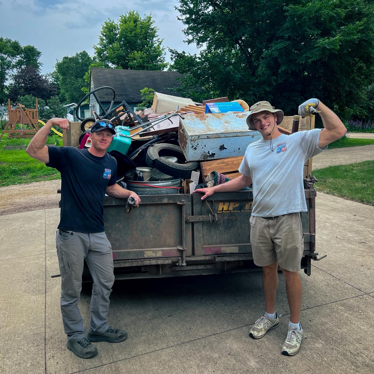 Noah Christensen, owner of WeHaul Hauling & Junk Removal, in front of a fully loaded WeHaul dump trailer in Sioux Falls, SD